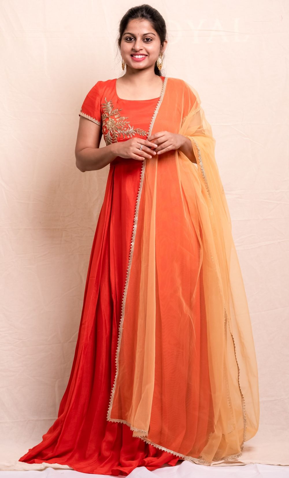 Orange long dress with a hand emdroidered body and a contrast light orange dupatta