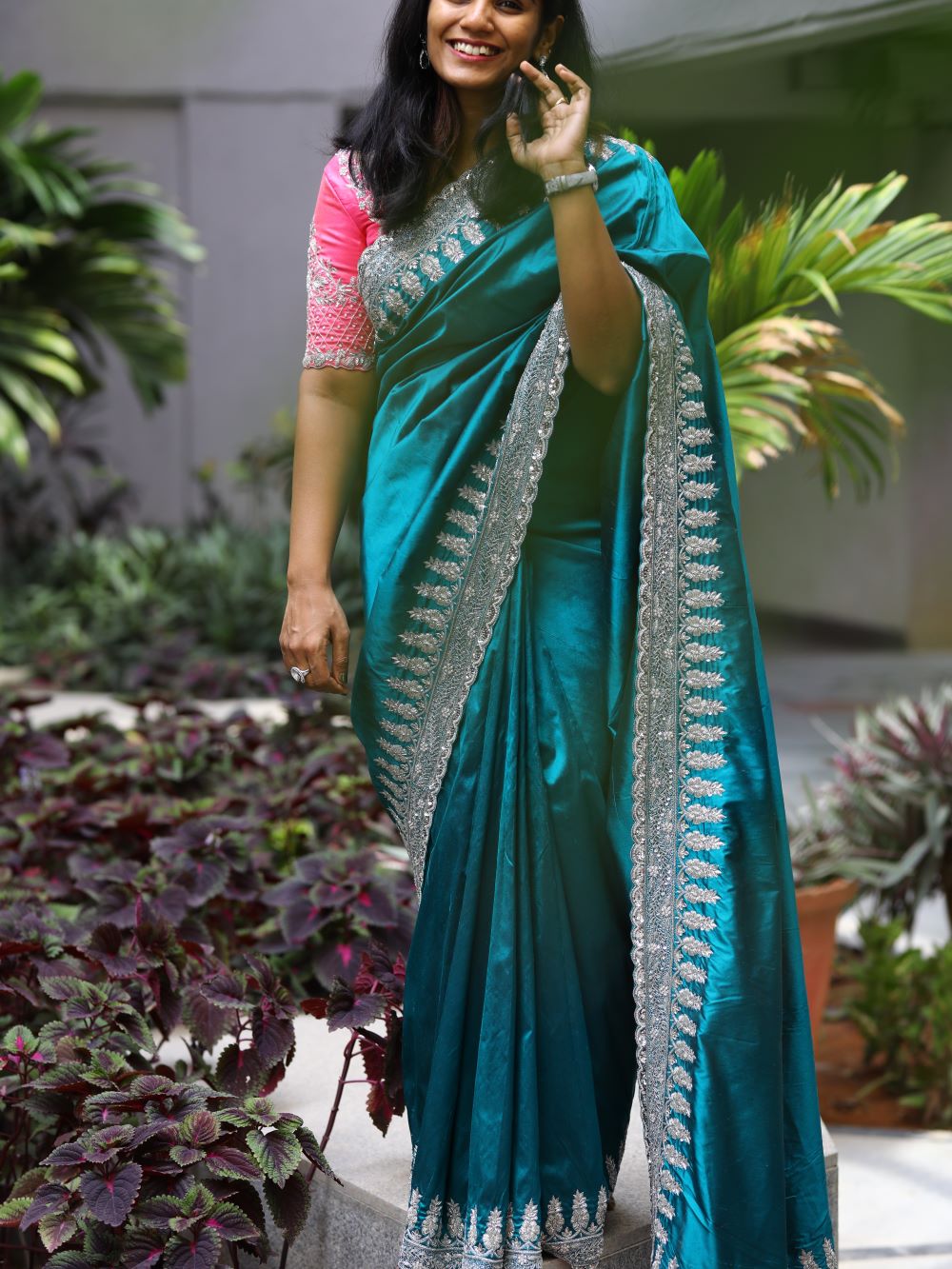 Pure pattu saree with hand embroidered border all over paired with a hot pink embroidered blouse
