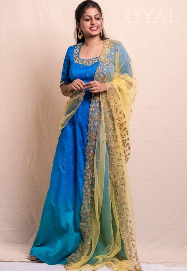 Peacock blue long dress with a hand emdroidered body and a contrast yellow dupatta