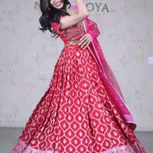 Red self pattern lehenga paired with embroidered blouse