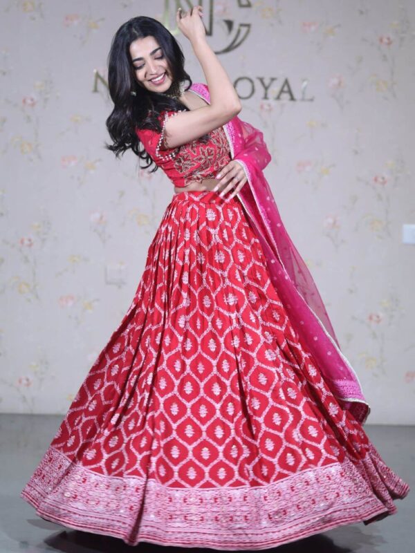 Red self pattern lehenga paired with embroidered blouse