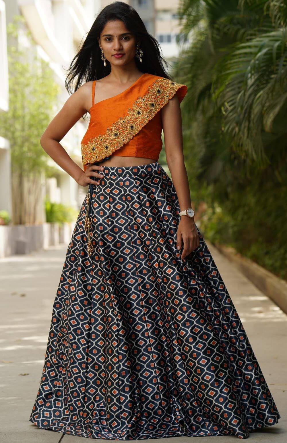 A line skirt paired with a one shoulder embroidered crop top