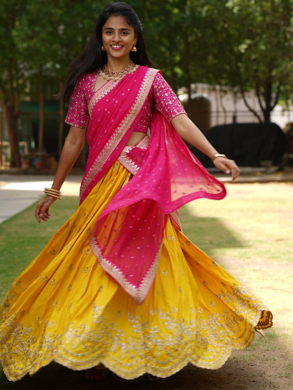 Yellow raw silk lehenga Paired with a embroidered pink blouse